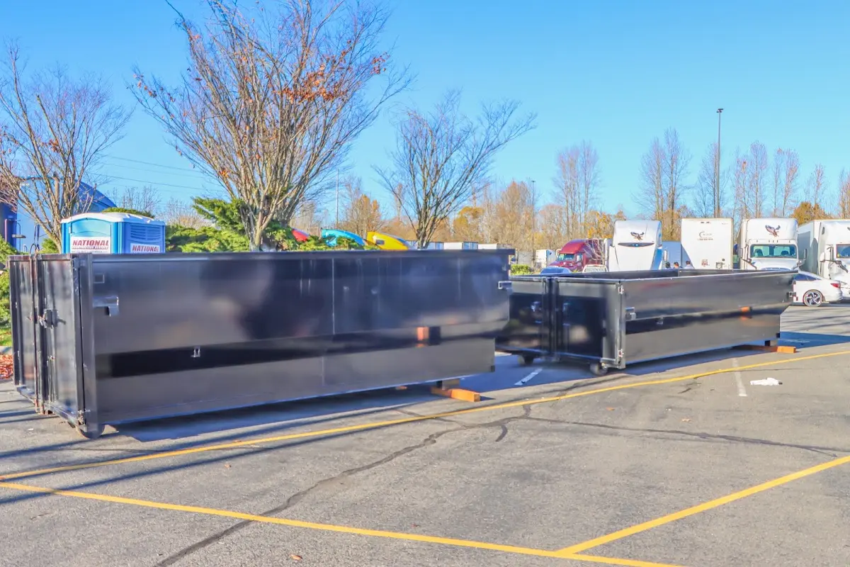 Professional dumpster rental service with roll-off container on residential driveway in New Port Richey East